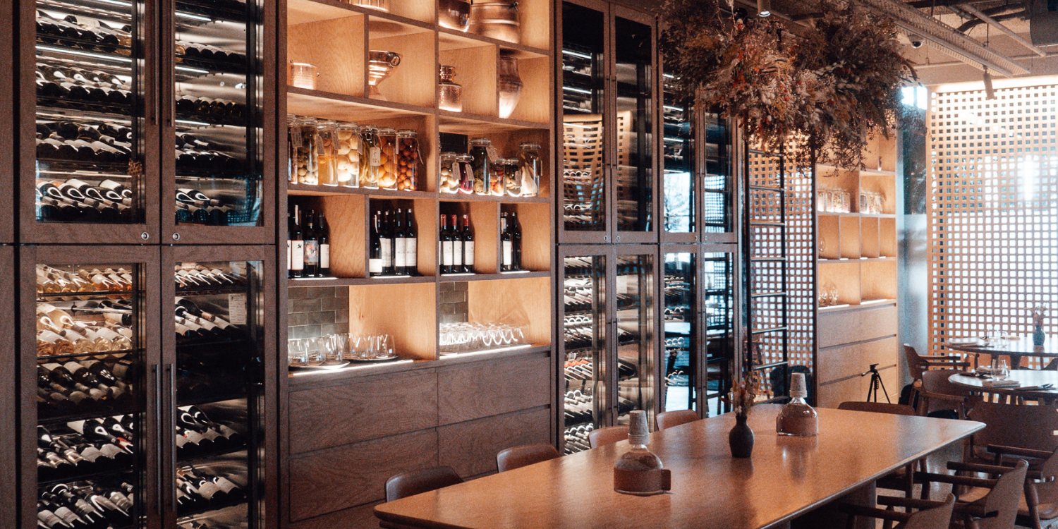 Wine cellar with wooden tables and chairs in a restaurant setting